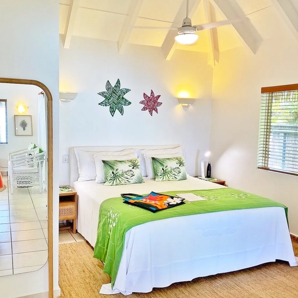 A bedroom inside a beachfront villa at MOTU resort